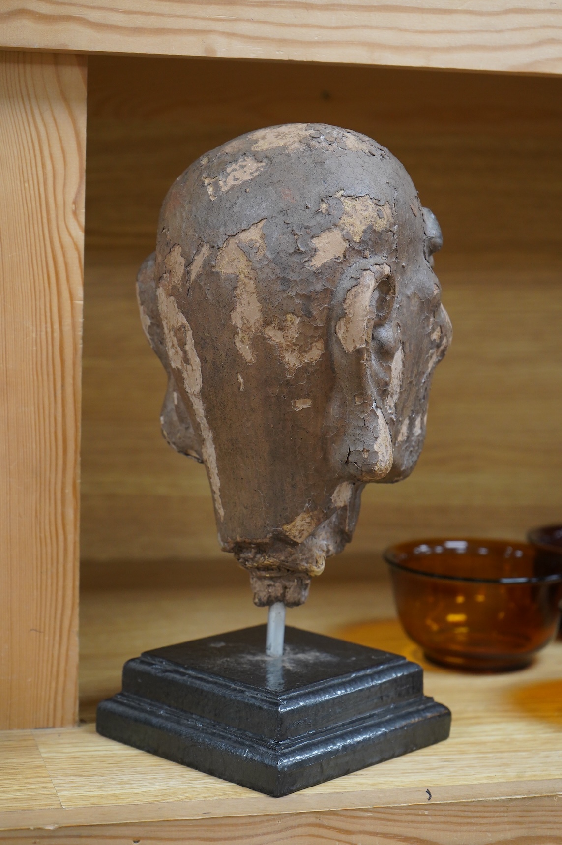 A Chinese lacquered composition head of a Luohan, early Ming, 28cm including stand
